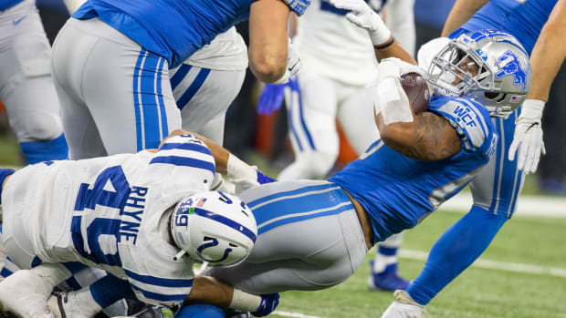 Aug 20, 2022; Indianapolis, Indiana, USA; Detroit Lions running back Jamaal Williams (30) runs the ball while Indianapolis Colts linebacker Forrest Rhyne (49) defends in the first quarter at Lucas Oil Stadium. Mandatory Credit: Trevor Ruszkowski-USA TODAY Sports  
